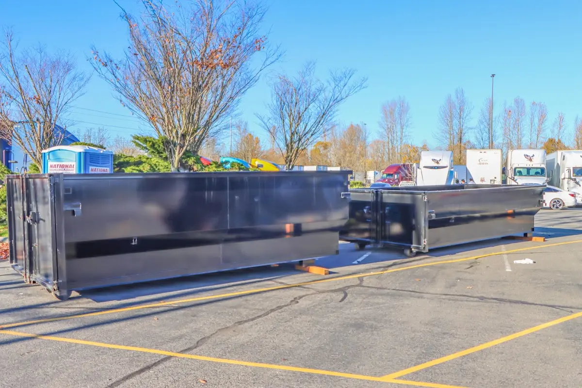 Professional dumpster rental service with roll-off container on residential driveway in Scottdale